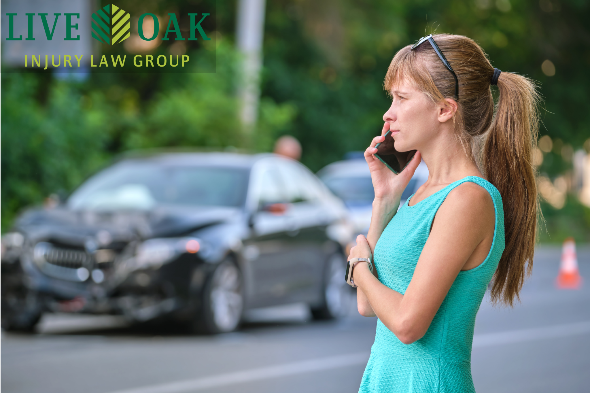 Young woman in turquoise dress on phone after Morgan Hill car accident with damaged black car in the background, showcasing Live Oak Injury Law Group's expertise.